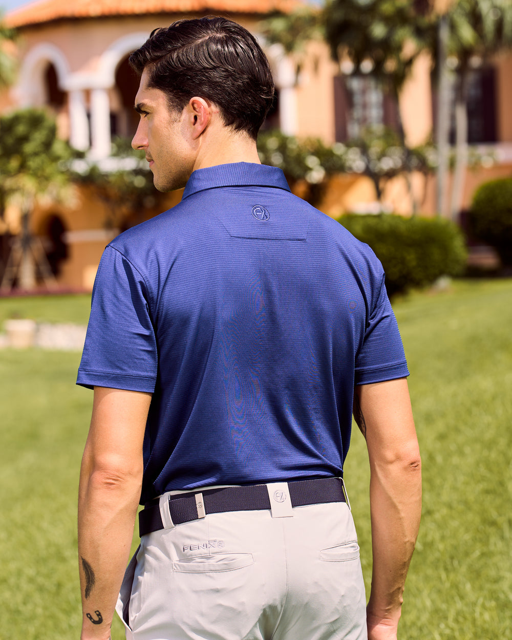 Fenix XCell blue performance golf polo featuring moisture-wicking fabric and tailored athletic fit.