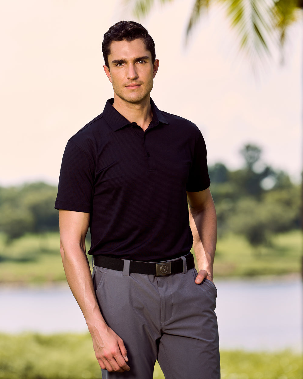 Fenix XCell black performance golf polo featuring moisture-wicking fabric and tailored athletic fit.